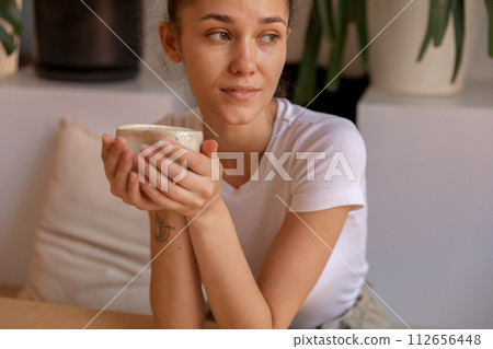 A girl with hand made mug sitting at table A girl with hand made mug sitting at table 112656448