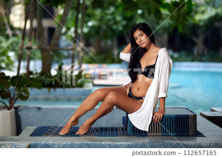 Young asian sexy girl in a white bikini posing at hotel territory 112657165