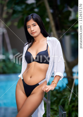 Young asian sexy girl in a white bikini posing at hotel territory 112657170
