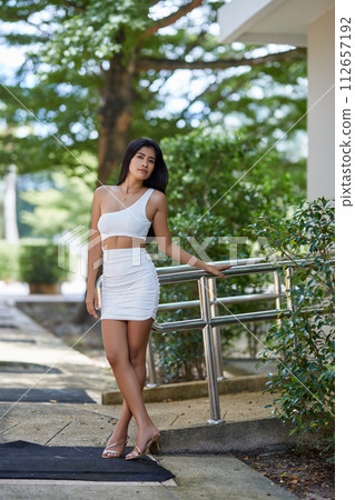 Young asian sexy woman in a white dress posing at hotel territory Young asian sexy woman in a white dress posing at hotel territory 112657192