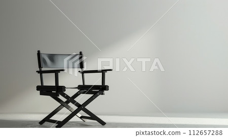 Black director's chair against a white wall. Makeup's chair. copy space 112657288