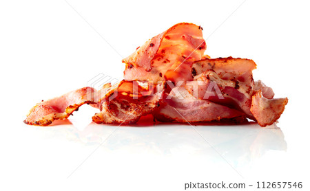 Fried bacon slices isolated on white. Fried bacon slices isolated on white. 112657546