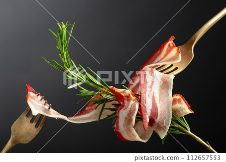 Dry-cured pork belly bacon with rosemary. Dry-cured pork belly bacon with rosemary. 112657553