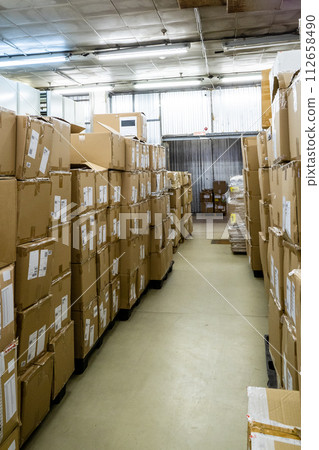 stockroom with cardboard boxes on pallets stockroom with cardboard boxes on pallets 112658490