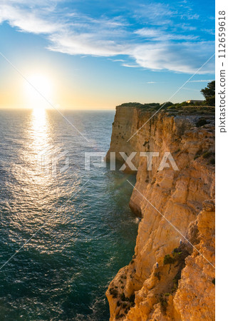 Natural caves and beach, Algarve Portugal. Rock cliff arches of Seven Hanging Valleys and turquoise sea water on coast of Portugal in Algarve region 112659618