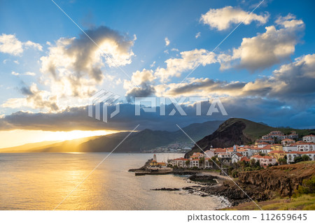 Sunset on Ponta de Sao Lourenco peninsula with traditional resort village. Madeira Island Portugal. Sunset on Ponta de Sao Lourenco peninsula with traditional resort village. Madeira Island Portugal. 112659645