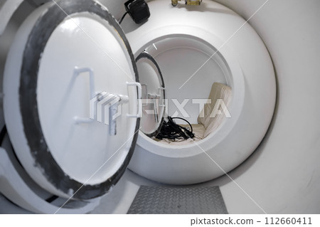 Interior of a white hyperbaric chamber 112660411