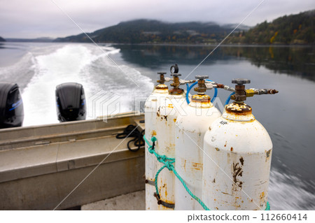 Dive bottles on a small boat outdoors 112660414