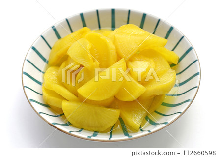 Sweet and tart slices of yellow pickled daikon, known as takuan in Japan and danmuji in Korea. 112660598