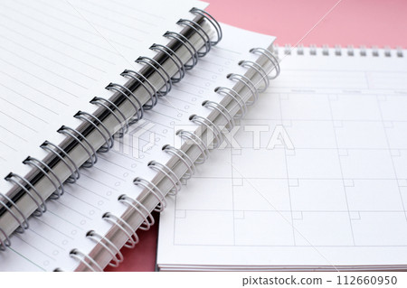 Notebook and calendar on pink background. Work planning 112660950