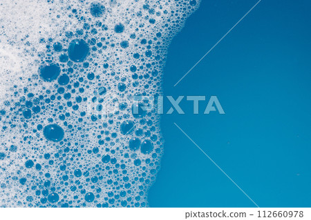 Detergent foam bubble on water. Blue background, Soap sud Detergent foam bubble on water. Blue background, Soap sud 112660978