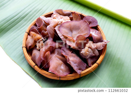Black fungus mushroom on banana leaf 112661032