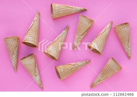 Empty ice cream cone on pink background. 112661466