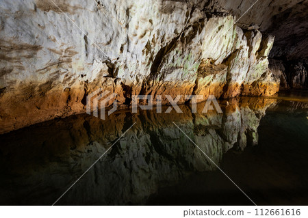 Akiyoshido cave wall and water mirror Akiyoshido cave wall and water mirror 112661616