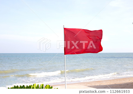 A red flag. Warning sign on the beach 112661933