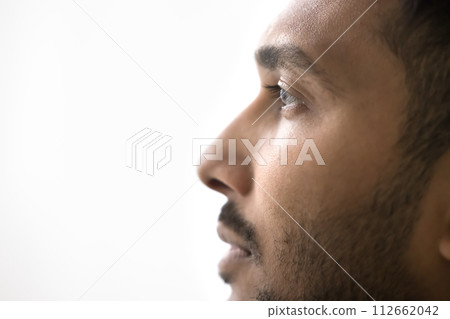 Closeup profile of serious Indian man on white gray background Closeup profile of serious Indian man on white gray background 112662042