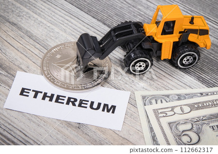 Ethereum, miniature excavator and dollars. Cryptocurrency Ethereum, miniature excavator and dollars. Cryptocurrency 112662317