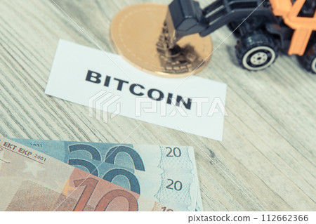 Bitcoin, miniature excavator and euro. Cryptocurrency 112662366