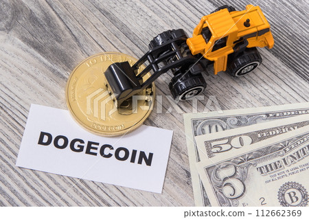 Dogecoin, miniature excavator and dollars. Cryptocurrency Dogecoin, miniature excavator and dollars. Cryptocurrency 112662369