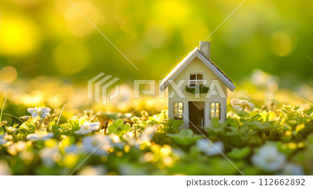 AI-generated content. Tiny toy house on spring grass sprouts. 112662892