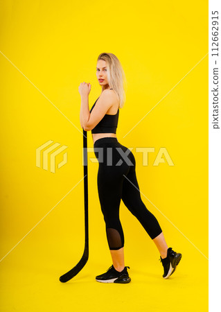 Luxuriously dressed female with a hockey stick. Women's winter sports. 112662915
