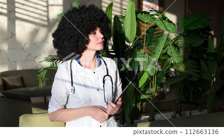 Woman doctor in a modern hospital with a beautiful interior Woman doctor in a modern hospital with a beautiful interior 112663136