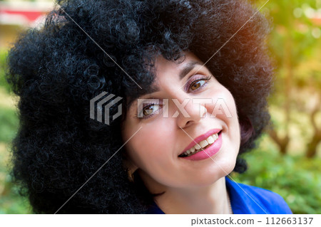 Woman about 30 years old in a blue dress portrait near a tree Woman about 30 years old in a blue dress portrait near a tree 112663137