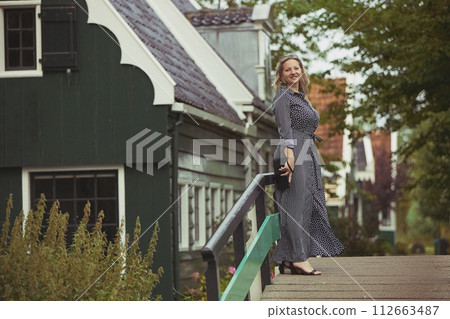 Beautiful woman in a dress in the evening Zaanstad, Netherlands Beautiful woman in a dress in the evening Zaanstad, Netherlands 112663487
