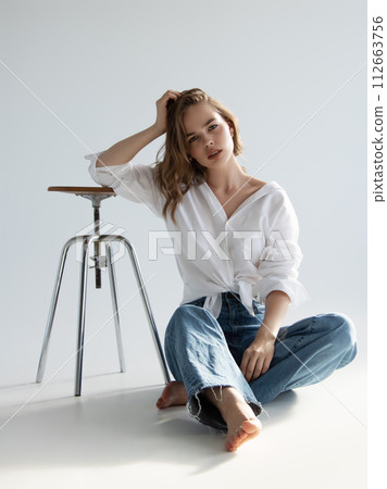 Beautiful girl model with light makeup in white 112663756