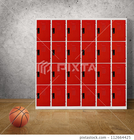Basketball in room floor with locker in the background 112664425