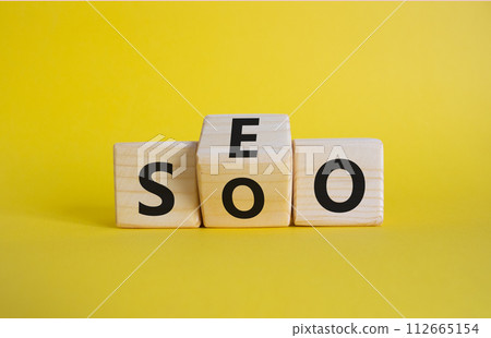 SEO vs SOO symbol. Wooden cubes with words SOO and SEO. Beautiful yellow background. SEO vs SOO and business concept. Copy space SEO vs SOO symbol. Wooden cubes with words SOO and SEO. Beautiful yellow background. SEO vs SOO and business concept. Copy space 112665154