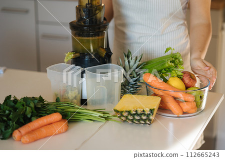Middle selection of table with fruits and vegetable for fresh juice. Homemade beverage in juicer. Healthy concept Middle selection of table with fruits and vegetable for fresh juice. Homemade beverage in juicer. Healthy concept 112665243