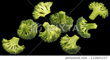 Falling broccoli isolated on black background Falling broccoli isolated on black background 112665257