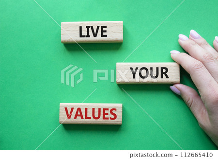 Live your values symbol. Concept words Live your values on wooden blocks. Beautiful green background. Businessman hand. Business and Live your values concept. Copy space. Live your values symbol. Concept words Live your values on wooden blocks. Beautiful green background. Businessman hand. Business and Live your values concept. Copy space. 112665410