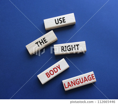 Use the right Body Language symbol. Concept words Use the right Body Language on wooden blocks. Beautiful deep blue background. Business concept. Copy space 112665446