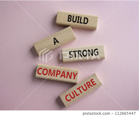 Company culture symbol. Wooden blocks with words Build a strong company culture. Beautiful pink background. Business and Company culture concept. Copy space. Company culture symbol. Wooden blocks with words Build a strong company culture. Beautiful pink background. Business and Company culture concept. Copy space. 112665447