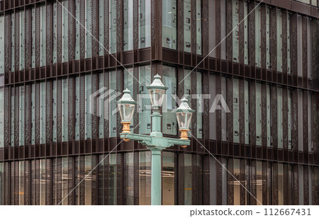 Decorative street lamp on Southwark bridge against the background of Modern building. Decorative street lamp on Southwark bridge against the background of Modern building. 112667431