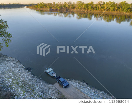 launching a fishing boat at a ramp - sunrise aerial view of Missouri River at Dalton Bottom launching a fishing boat at a ramp - sunrise aerial view of Missouri River at Dalton Bottom 112668054