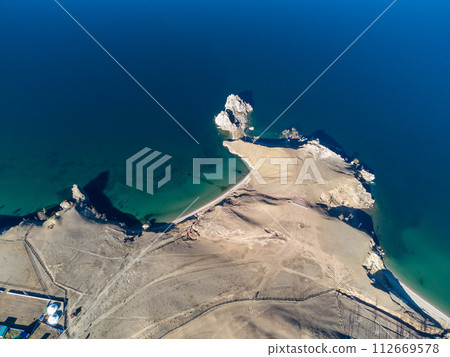 Sarayskiy beach. Shamanka Rock. Lake Baikal at Olkhon Island. the village of Khuzhir Sarayskiy beach. Shamanka Rock. Lake Baikal at Olkhon Island. the village of Khuzhir 112669578