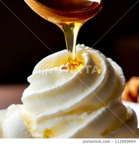 The moment you pour honey on soft serve ice cream 112669604