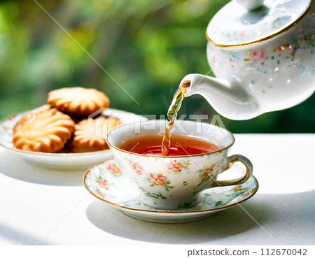The moment you pour tea into an elegant teacup The moment you pour tea into an elegant teacup 112670042