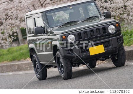 Cherry blossoms in full bloom 4WD light car driving drive 112670362