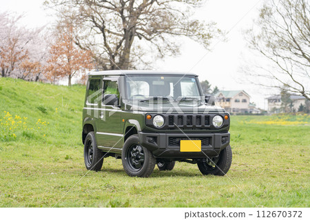 Cherry blossoms in full bloom 4WD light car driving drive 112670372