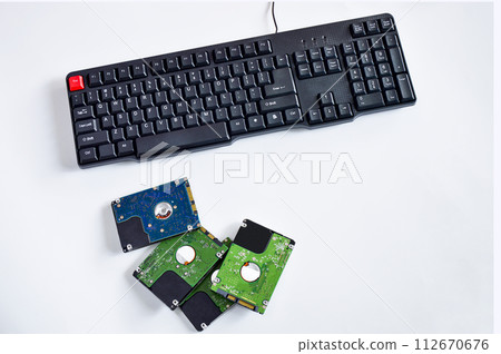 2.5-inch hard drive, swivel plate and keyboard keys on a white background 2.5-inch hard drive, swivel plate and keyboard keys on a white background 112670676
