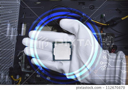 Picture of a hand wearing white gloves with a CPU chip placed on it. 112670870