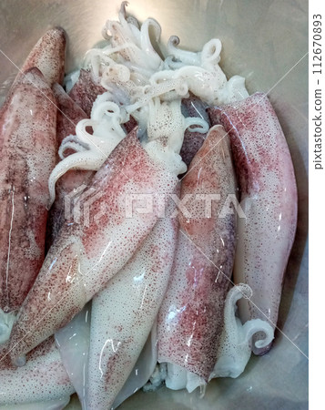Fresh squid prepared for cooking 112670893