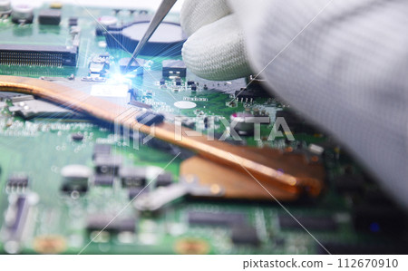 View from the top while a technician is fixing the motherboard. 112670910