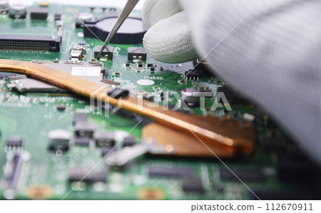 View from the top while a technician is fixing the motherboard. 112670911