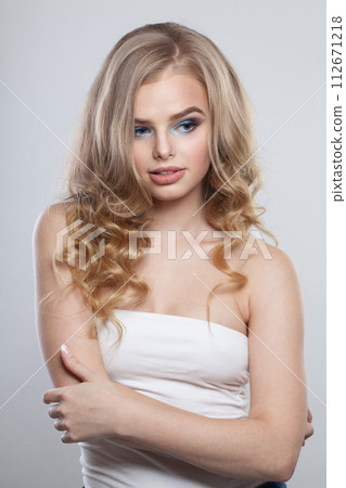 Cute young fashion woman with healthy blonde hair and make-up on white background Cute young fashion woman with healthy blonde hair and make-up on white background 112671218