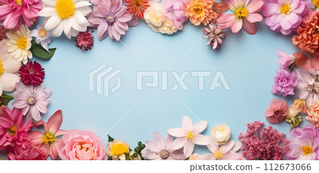 Flat lay composition of spring colorful flowers on a blue background with space for text 112673066